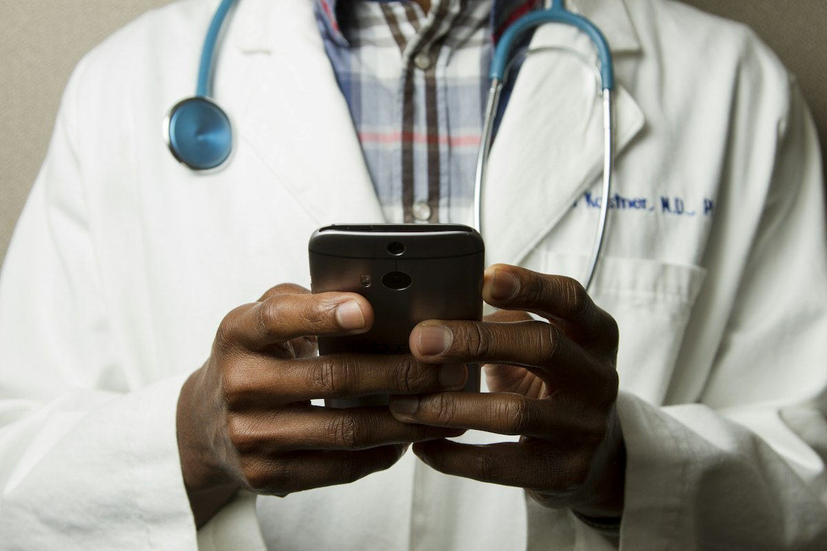 TRON Care telemedicine doctor with tablet